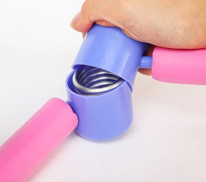 close-up of the durable steel spring hinge mechanism inside a blue plastic casing on a pink thigh exerciser